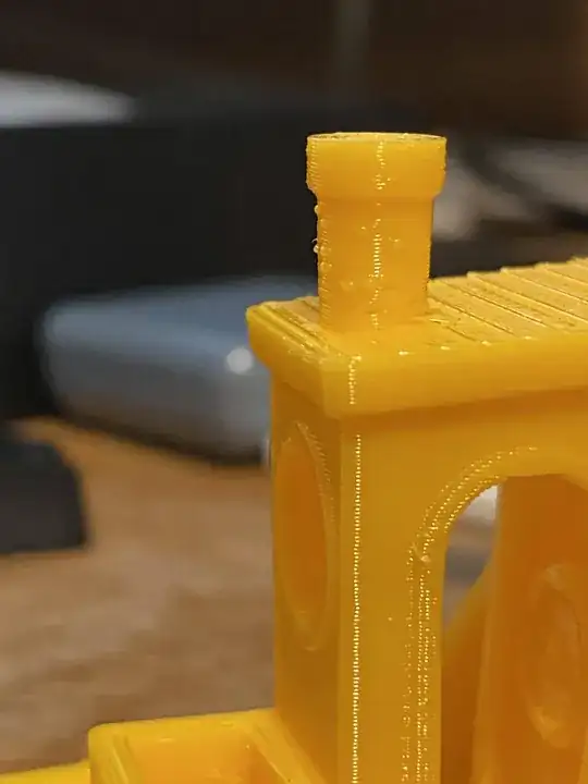 Photo of a printed benchy with zits on the chimney