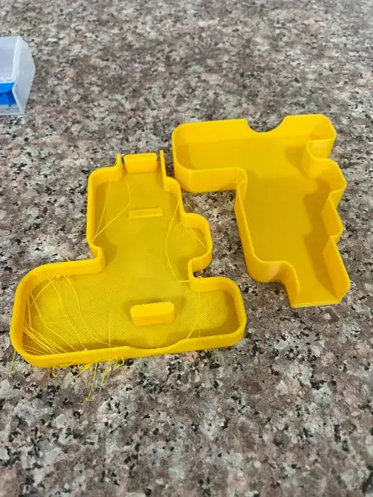 Photo of two printed models, the left model has stringing while the right one doesn't