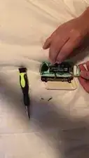 Use the tweezers to lift the ZL button a little then pull upwards to get it back into place.