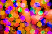 An example of the bokeh produced by the Canon 85 mm prime f/1.8 lens. The polygonal shapes are due to the 8-bladed aperture diaphragm being slightly closed. At its full aperture (f/1.8) these shapes would be smooth and not polygonal.