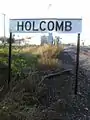 The railroad sign for Holcomb. As viewed looking North
