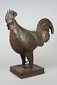 Rooster figure; 18th century; brass; overall: 45.4 cm (17.mw-parser-output .frac{white-space:nowrap}.mw-parser-output .frac .num,.mw-parser-output .frac .den{font-size:80%;line-height:0;vertical-align:super}.mw-parser-output .frac .den{vertical-align:sub}.mw-parser-output .sr-only{border:0;clip:rect(0,0,0,0);height:1px;margin:-1px;overflow:hidden;padding:0;position:absolute;width:1px}7⁄8 in.); Metropolitan Museum of Art