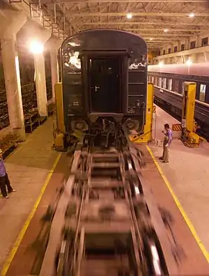 Wheels rolling below an elevated carriage during the wheel changing from Mongolian to Chinese gauge